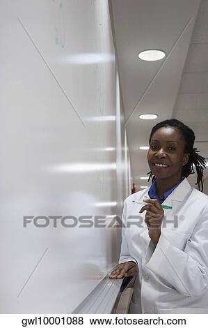Female doctor writing on a whiteboard in a hospital View Large Photo Image Stock Photo - Female doctor writing on a whiteboard in a hospital. Fotosearch