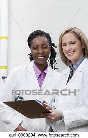 Picture - Female doctors working in a laboratory. Fotosearch