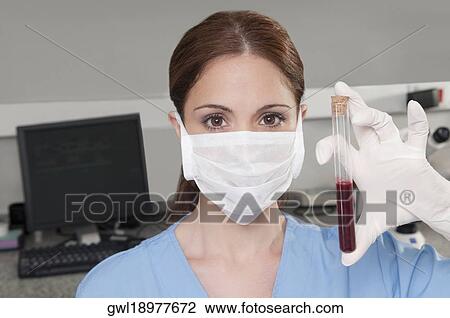 Female lab technician analyzing a blood sample in a test tube View Large Photo Image Stock Image - Female lab technician analyzing a blood sample in a test tube. Fotosearch