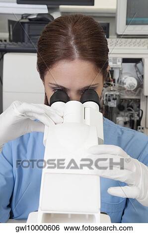 Female lab technician analyzing a sample through a microscope View Large Photo Image Stock Photograph - Female lab technician analyzing a sample through a microscope. Fotosearch