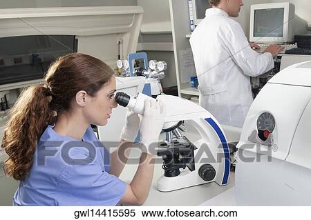 Female lab technician analyzing a sample through a microscope View Large Photo Image Stock Photography - Female lab technician analyzing a sample through a microscope. Fotosearch
