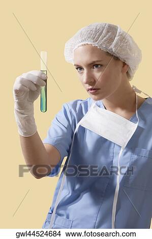 Female lab technician analyzing a test tube View Large Photo Image Picture - Female lab technician analyzing a test tube. Fotosearch