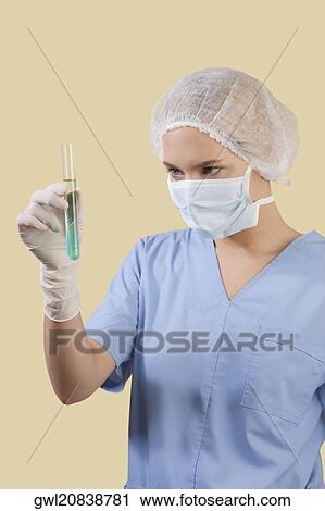 Female lab technician analyzing a test tube View Large Photo Image Stock Image - Female lab technician analyzing a test tube. Fotosearch
