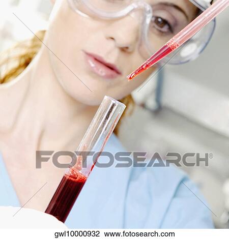 Female lab technician holding blood sample in a test tube View Large Photo Image Stock Image - Female lab technician holding blood sample in a test tube. Fotosearch