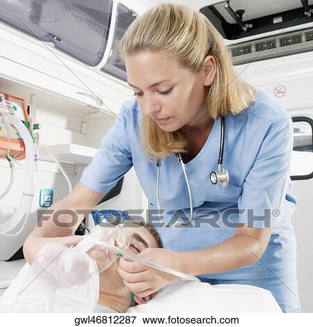 Female nurse adjusting oxygen mask of a patient View Large Photo Image Stock Photo - Female nurse adjusting oxygen mask of a patient. Fotosearch