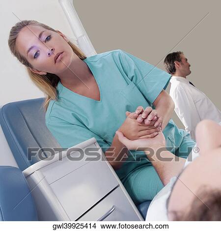 Female nurse assisting a patient in an ambulance View Large Photo Image Picture - Female nurse assisting a patient in an ambulance. Fotosearch