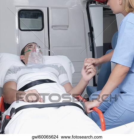 Female nurse assisting a patient in an ambulance View Large Photo Image Picture - Female nurse assisting a patient in an ambulance. Fotosearch