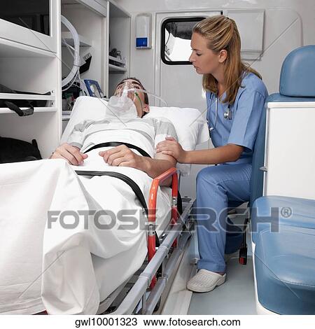 Female nurse assisting a patient in an ambulance View Large Photo Image Stock Image - Female nurse assisting a patient in an ambulance. Fotosearch