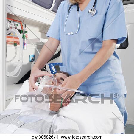 Female nurse assisting a patient in an ambulance View Large Photo Image Stock Image - Female nurse assisting a patient in an ambulance. Fotosearch