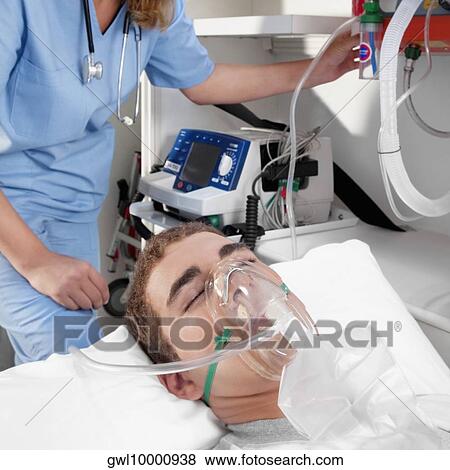 Female nurse assisting a patient in an ambulance View Large Photo Image Stock Photo - Female nurse assisting a patient in an ambulance. Fotosearch