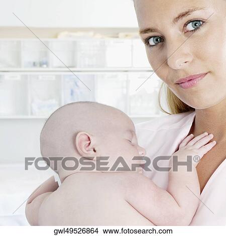 Female nurse carrying a newborn baby View Large Photo Image Picture - Female nurse carrying a newborn baby. Fotosearch