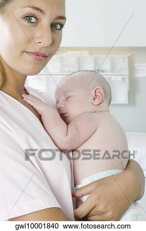 Female nurse carrying a newborn baby View Large Photo Image Stock Image - Female nurse carrying a newborn baby. Fotosearch