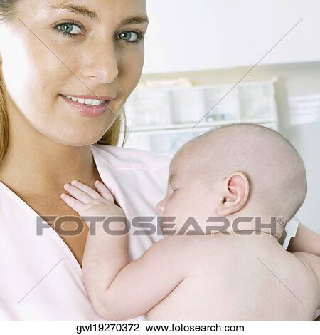 Female nurse carrying a newborn baby View Large Photo Image Stock Image - Female nurse carrying a newborn baby. Fotosearch