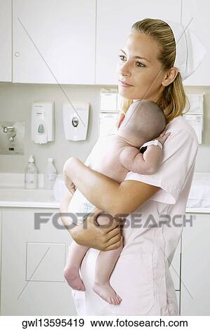 Female nurse carrying a newborn baby View Large Photo Image Stock Photo - Female nurse carrying a newborn baby. Fotosearch