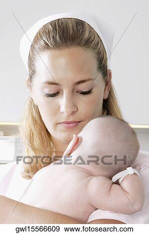 Female nurse carrying a newborn baby View Large Photo Image Stock Photo - Female nurse carrying a newborn baby. Fotosearch