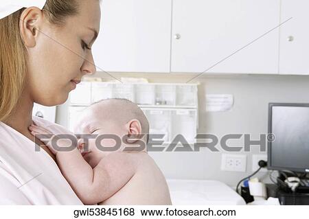 Female nurse carrying a newborn baby View Large Photo Image Stock Photo - Female nurse carrying a newborn baby. Fotosearch