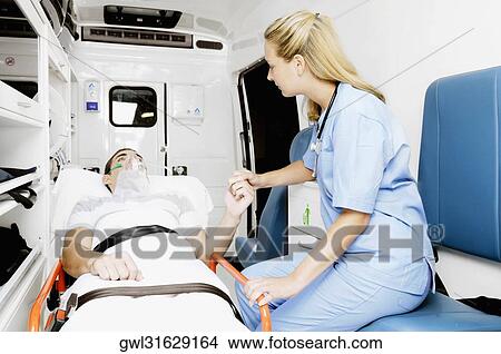 Female nurse consoling a patient in an ambulance View Large Photo Image Picture - Female nurse consoling a patient in an ambulance. Fotosearch