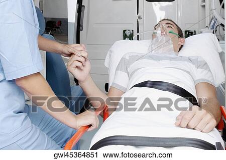 Female nurse consoling a patient in an ambulance View Large Photo Image Stock Image - Female nurse consoling a patient in an ambulance. Fotosearch