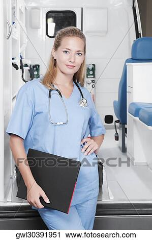 Female nurse standing in front of an ambulance View Large Photo Image Stock Image - Female nurse standing in front of an ambulance. Fotosearch