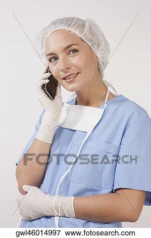 Female nurse talking on a mobile phone View Large Photo Image Stock Photo - Female nurse talking on a mobile phone. Fotosearch