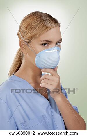 Female nurse wearing a flu mask View Large Photo Image Stock Image - Female nurse wearing a flu mask. Fotosearch