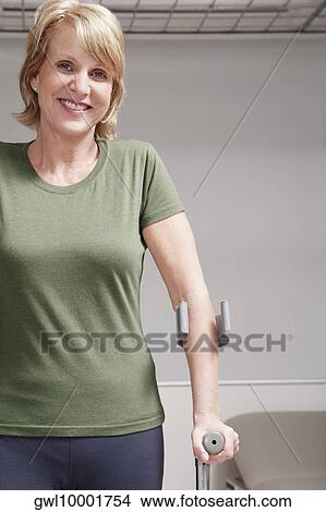 Female patient walking with crutches View Large Photo Image Picture - Female patient walking with crutches. Fotosearch