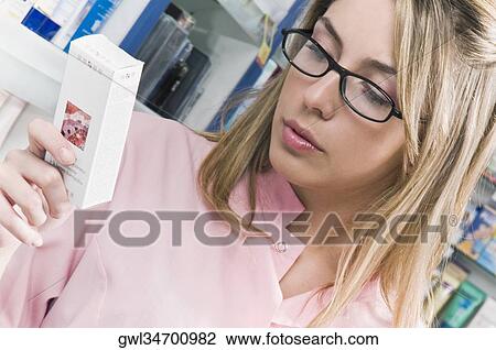 Female pharmacist holding a medicine View Large Photo Image Stock Image - Female pharmacist holding a medicine. Fotosearch