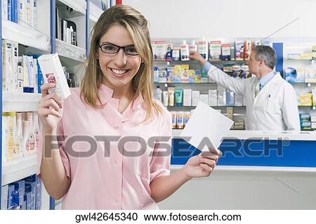 Female pharmacist holding a medicine with prescription View Large Photo Image Stock Image - Female pharmacist holding a medicine with prescription. Fotosearch