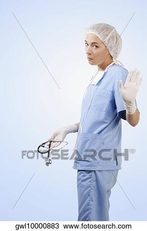 Female surgeon holding a stethoscope and gesturing View Large Photo Image Stock Image - Female surgeon holding a stethoscope and gesturing. Fotosearch