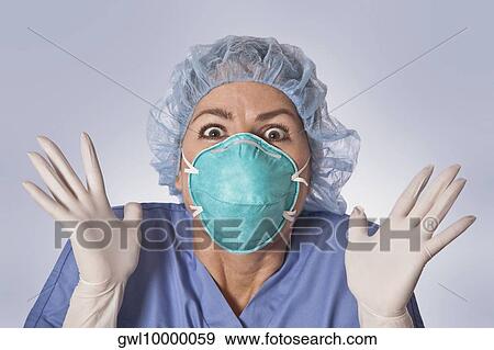 Female surgeon looking shocked View Large Photo Image Stock Photo - Female surgeon looking shocked. Fotosearch