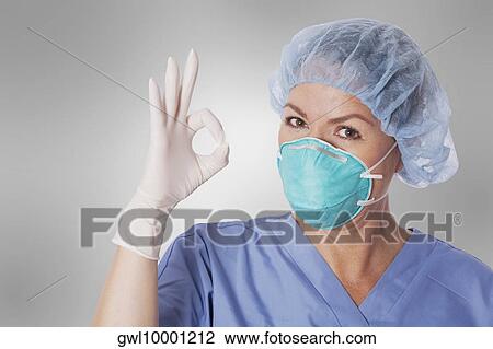 Female surgeon showing ok sign View Large Photo Image Stock Image - Female surgeon showing ok sign. Fotosearch