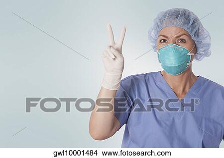 Female surgeon showing victory sign View Large Photo Image Picture - Female surgeon showing victory sign. Fotosearch