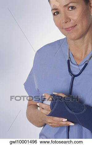 Stock Photograph - Female surgeon wearing a wrist brace. Fotosearch