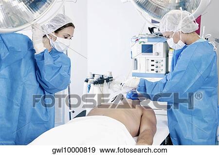 Female surgeons performing surgery View Large Photo Image Stock Photo - Female surgeons performing surgery. Fotosearch