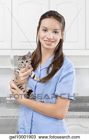 Female vet carrying a cat View Large Photo Image Stock Image - Female vet carrying a cat. Fotosearch