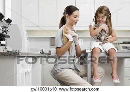 Female vet with a girl carrying cats View Large Photo Image Stock Image - Female vet with a girl carrying cats. Fotosearch