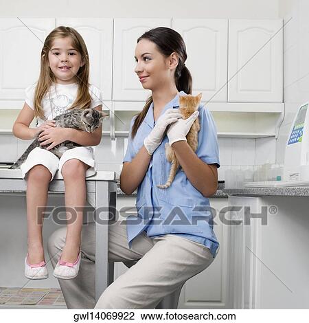 Female vet with a girl carrying cats View Large Photo Image Stock Image - Female vet with a girl carrying cats. Fotosearch