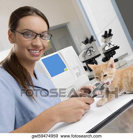 Stock Photo - Female vet writing a prescription. Fotosearch