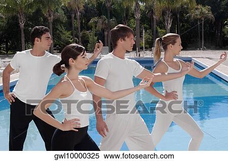 Four friends exercising at the poolside View Large Photo Image Stock Photography - Four friends exercising at the poolside. Fotosearch