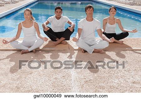 Four friends practicing yoga at the poolside View Large Photo Image Stock Photo - Four friends practicing yoga at the poolside. Fotosearch