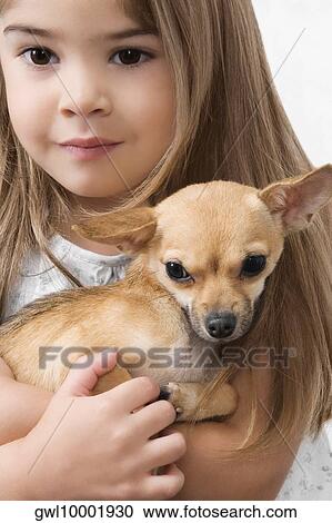 Girl carrying a dog in a veterinary hospital View Large Photo Image Stock Image - Girl carrying a dog in a veterinary hospital. Fotosearch