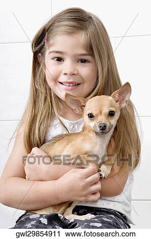 Girl carrying a dog in a veterinary hospital View Large Photo Image Stock Image - Girl carrying a dog in a veterinary hospital. Fotosearch