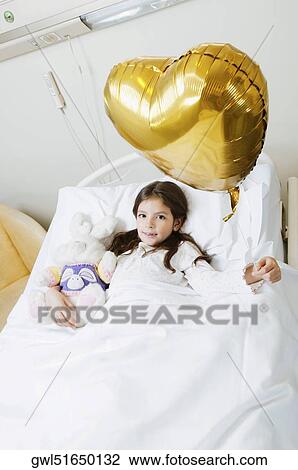 Girl holding a balloon on hospital bed View Large Photo Image Stock Image - Girl holding a balloon on hospital bed. Fotosearch