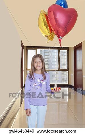 Girl holding balloons and smiling View Large Photo Image Stock Photo - Girl holding balloons and smiling. Fotosearch