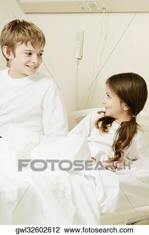 Girl on a hospital bed with her brother sitting beside her View Large Photo Image Stock Image - Girl on a hospital bed with her brother sitting beside her. Fotosearch