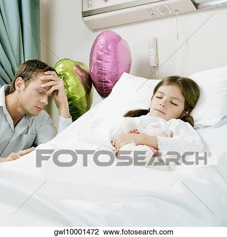 Girl on a hospital bed with her father looking worried beside her View Large Photo Image Stock Image - Girl on a hospital bed with her father looking worried beside her. Fotosearch
