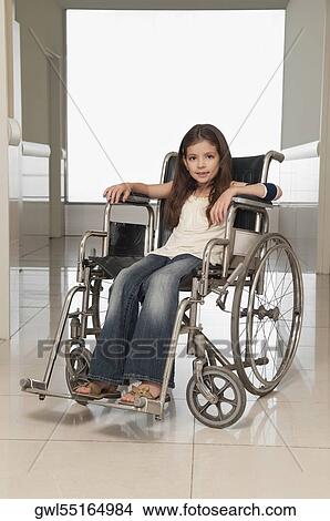Girl sitting in a wheelchair View Large Photo Image Picture - Girl sitting in a wheelchair. Fotosearch