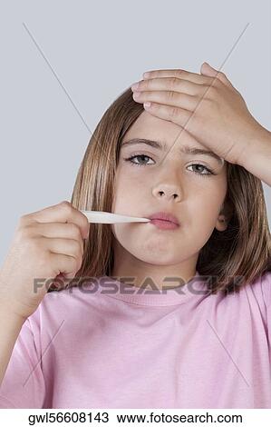 Girl taking her temperature View Large Photo Image Stock Image - Girl taking her temperature. Fotosearch
