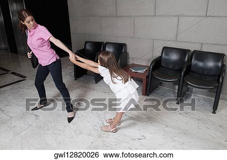 Girl tugging her mother in a hospital View Large Photo Image Stock Photograph - Girl tugging her mother in a hospital. Fotosearch