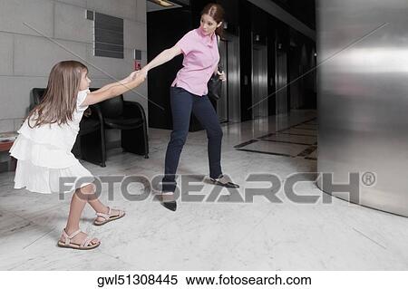 Girl tugging her mother in a hospital View Large Photo Image Stock Photography - Girl tugging her mother in a hospital. Fotosearch